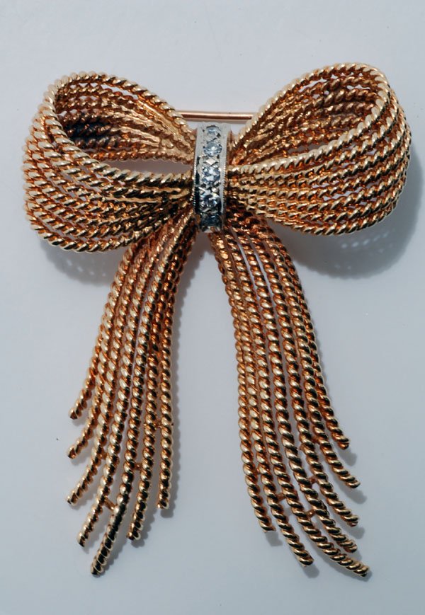 Appraisal: k yellow gold and diamond bow brooch with seven rope