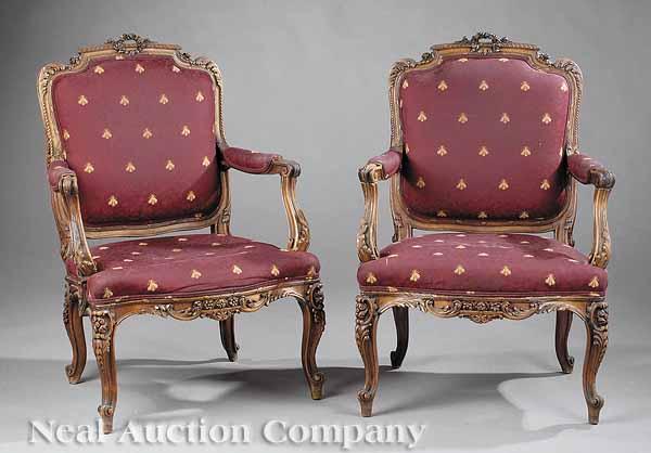 Appraisal: A Pair of Louis XV-Style Walnut Fauteuils foliate carved crests