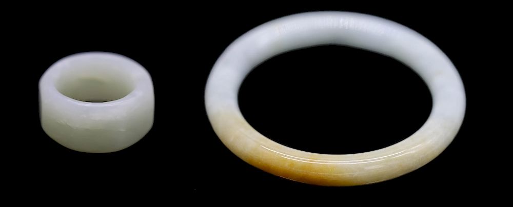 Appraisal: WHITE JADE RING AND JADEITE BANGLE Cylindrical jadeite bangle measuring