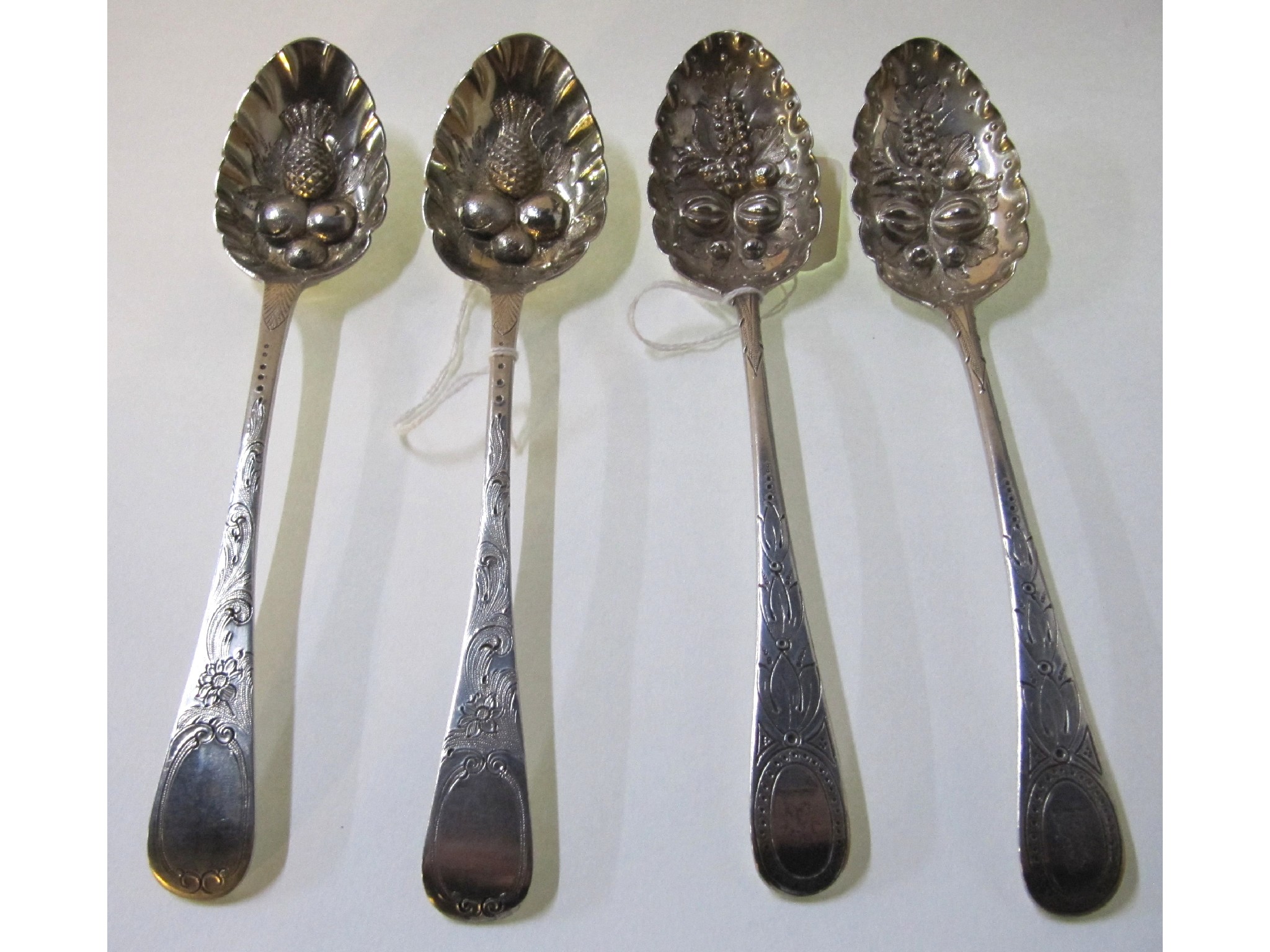 Appraisal: A lot comprising two pairs of silver berry spoons London