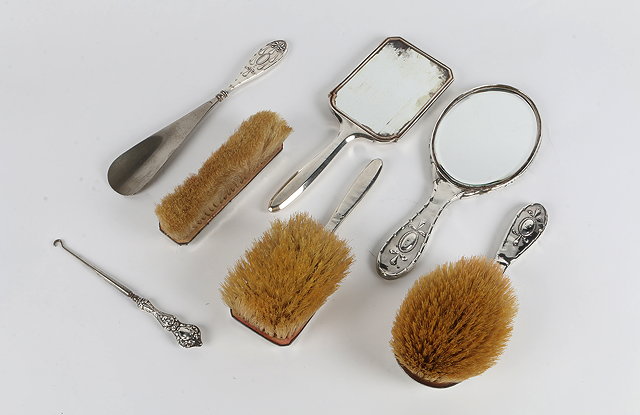 Appraisal: A THREE PIECE SILVER BACKED DRESSING TABLE SET with engine