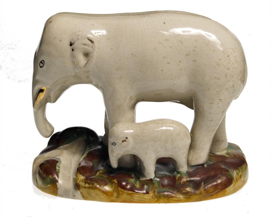 Appraisal: A STAFFORDSHIRE EARTHENWARE GROUP OF AN ELEPHANT AND CALF with