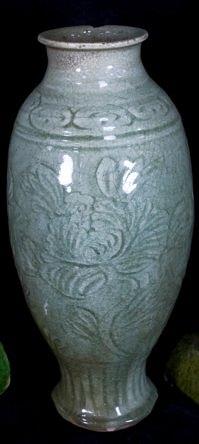 Appraisal: A celadon glazed baluster vase Ming incised with stylised peony