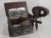 Appraisal: A stereoscopic viewer with approx slides in an oak box