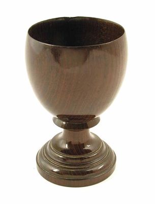 Appraisal: An early th century turned fruitwood goblet raised on spreading