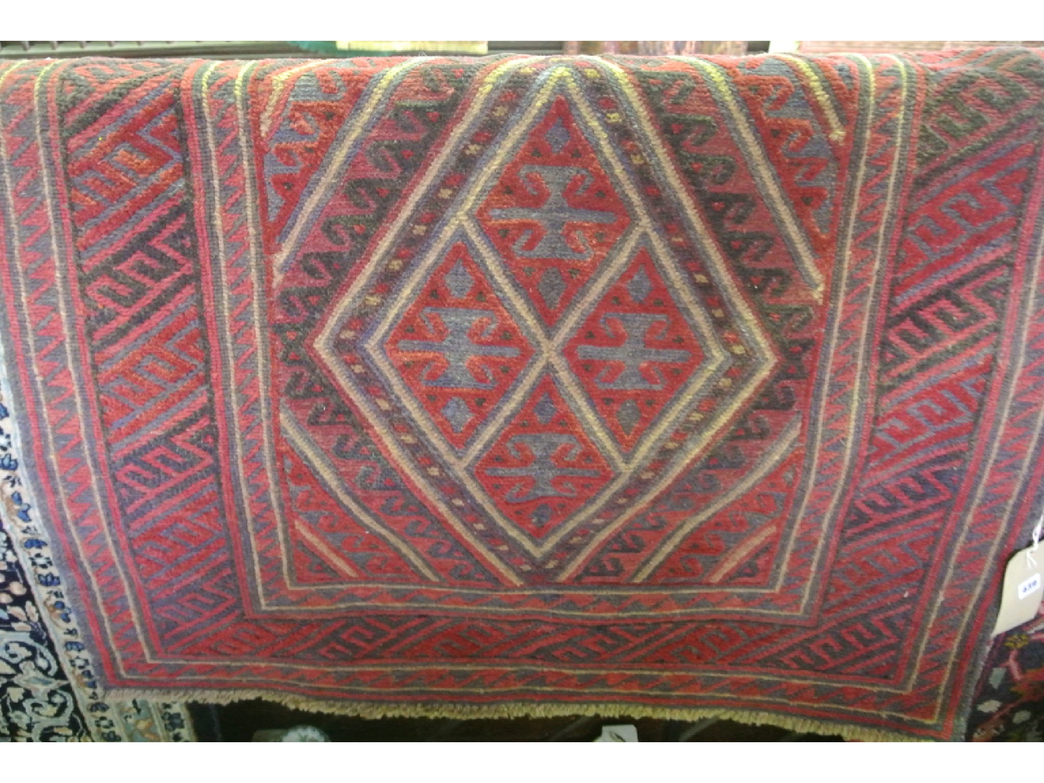 Appraisal: An eastern woven wool rug with central kite shaped medallion