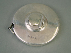 Appraisal: An Edwardian silver circular cased steel tape measure to '