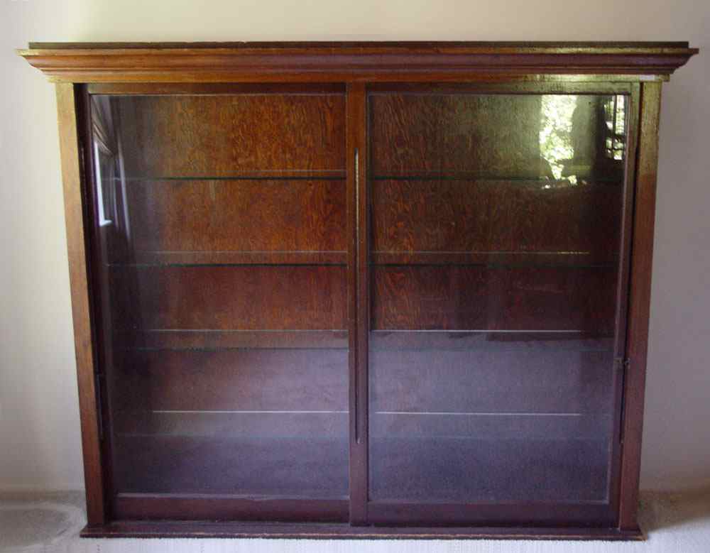 Appraisal: EARLY TH CENTURY GLASS FRONT STORE CABINET Sliding glass doors