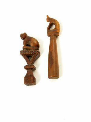 Appraisal: An th century carved treen pipe tamper with a seated