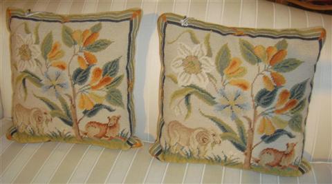 Appraisal: PAIR OF NEEDLEPOINT PILLOWS WITH FLOWERS AND ANIMALS w d