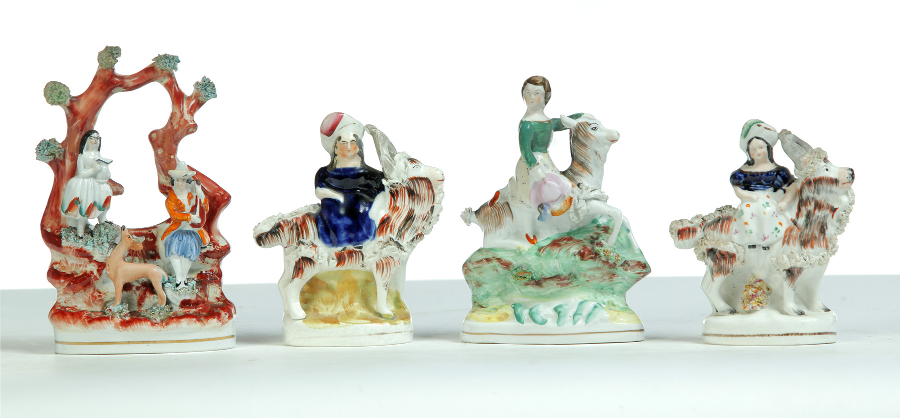 Appraisal: FOUR STAFFORDSHIRE FIGURINES England rd quarter- th century Lady and