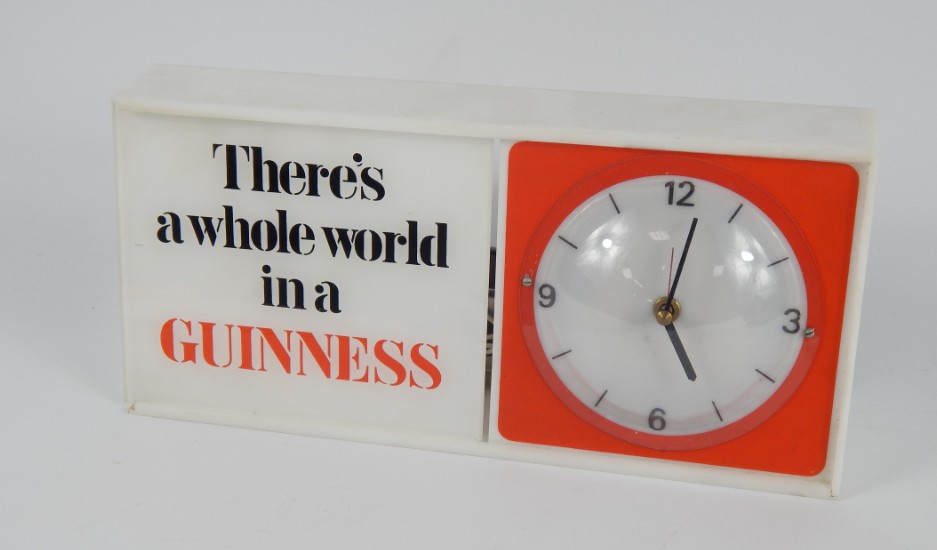 Appraisal: A Guinness plastic and perspex cased electric mantel clock rectangular