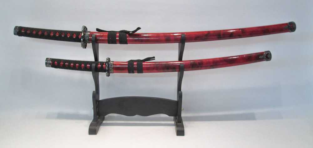 Appraisal: TWO JAPANESE STYLE SWORDS ON STAND Samurai styling with and