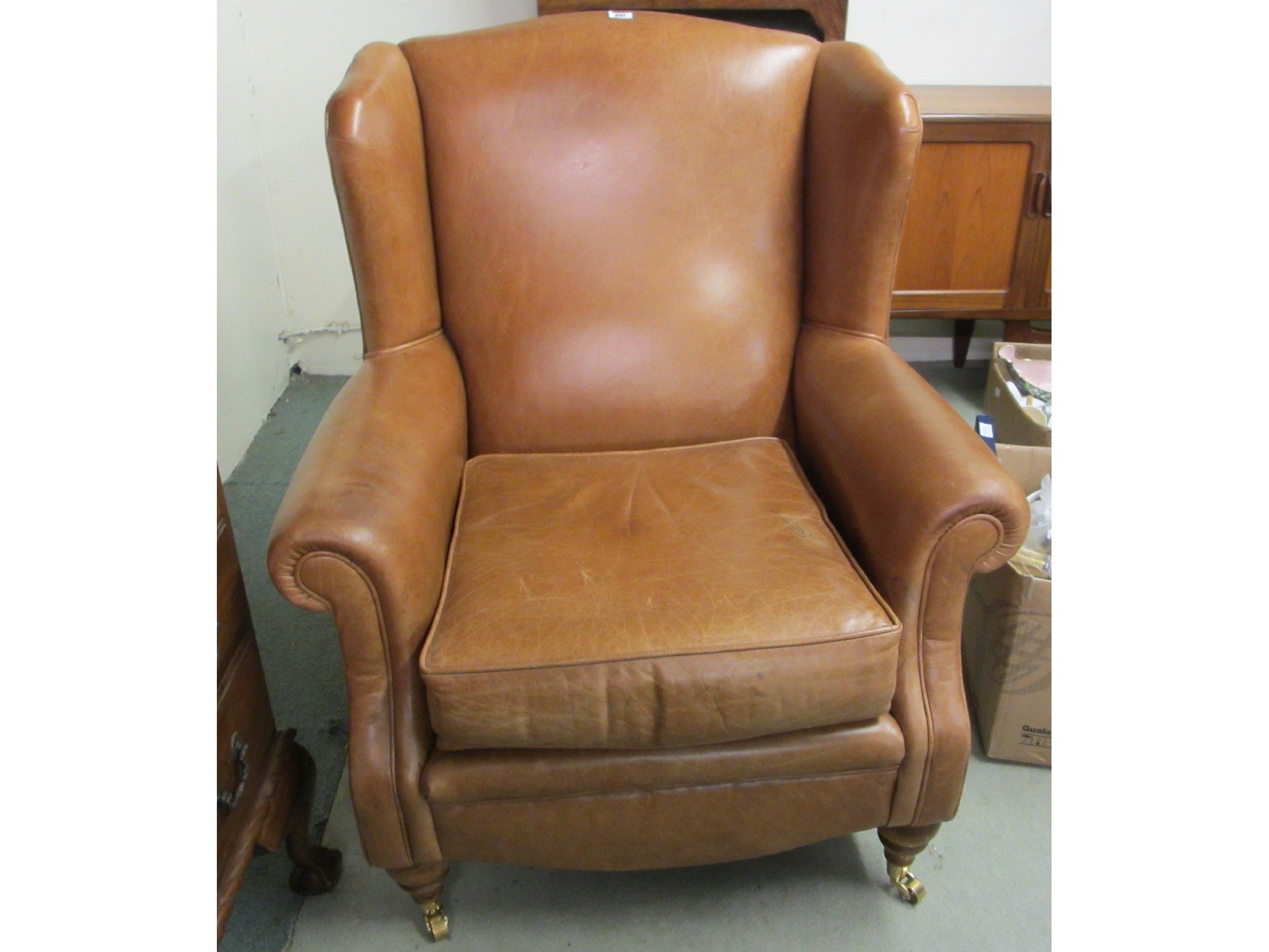 Appraisal: A leather upholstered wing armchair