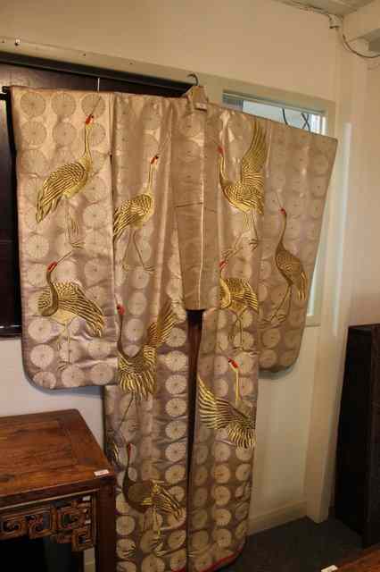 Appraisal: A JAPANESE CREAM SILK MARRIAGE COAT embroidered with storks and