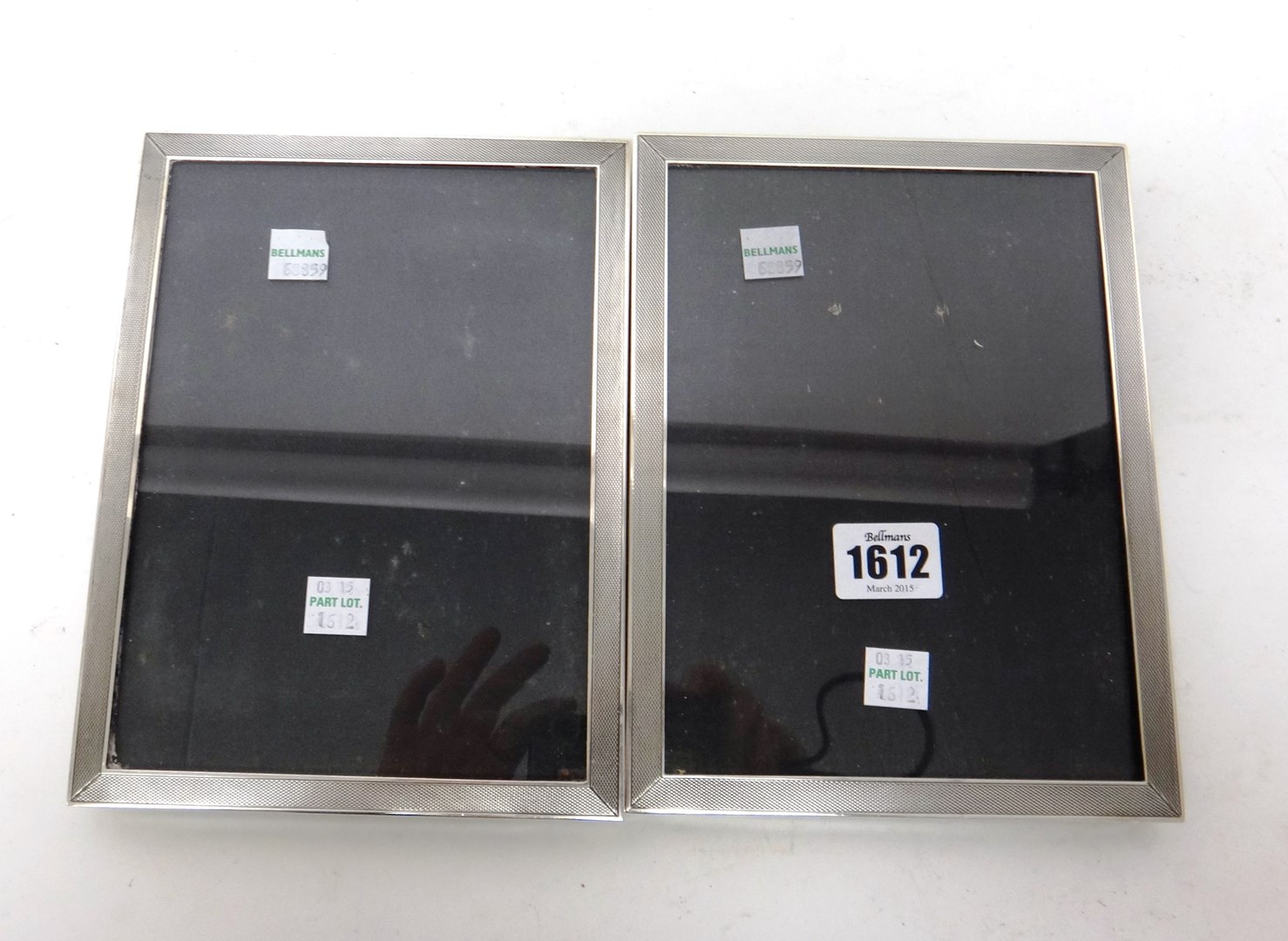 Appraisal: A near pair of silver mounted rectangular photograph frames decorated