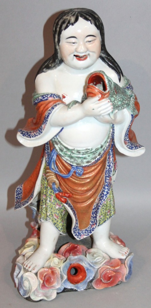 Appraisal: A Ming style Chinese figure of a standing figure holding