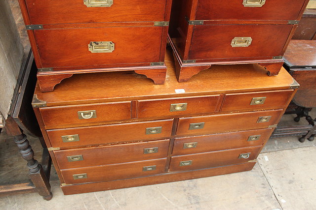 Appraisal: A REPRODUCTION MAHOGANY CAMPAIGN STYLE CHEST OF DRAWERS with recessed