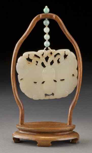 Appraisal: Chinese Qing carved white jade butterfly pendanthanging on a hardwood