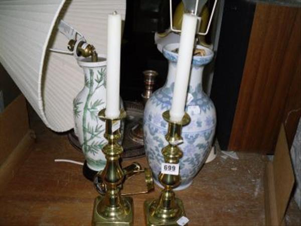 Appraisal: A pair of brass candlestick holders together with three table