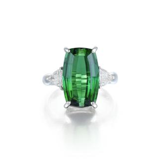 Appraisal: A Featuring a green tourmaline weighing approximately carats flanked by