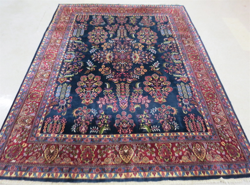 Appraisal: HAND KNOTTED ORIENTAL CARPET Indo-Sarouk floral sprig pattern on dark