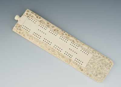 Appraisal: A Chinese Ivory Carved Cribbage Board Ornately carved on the