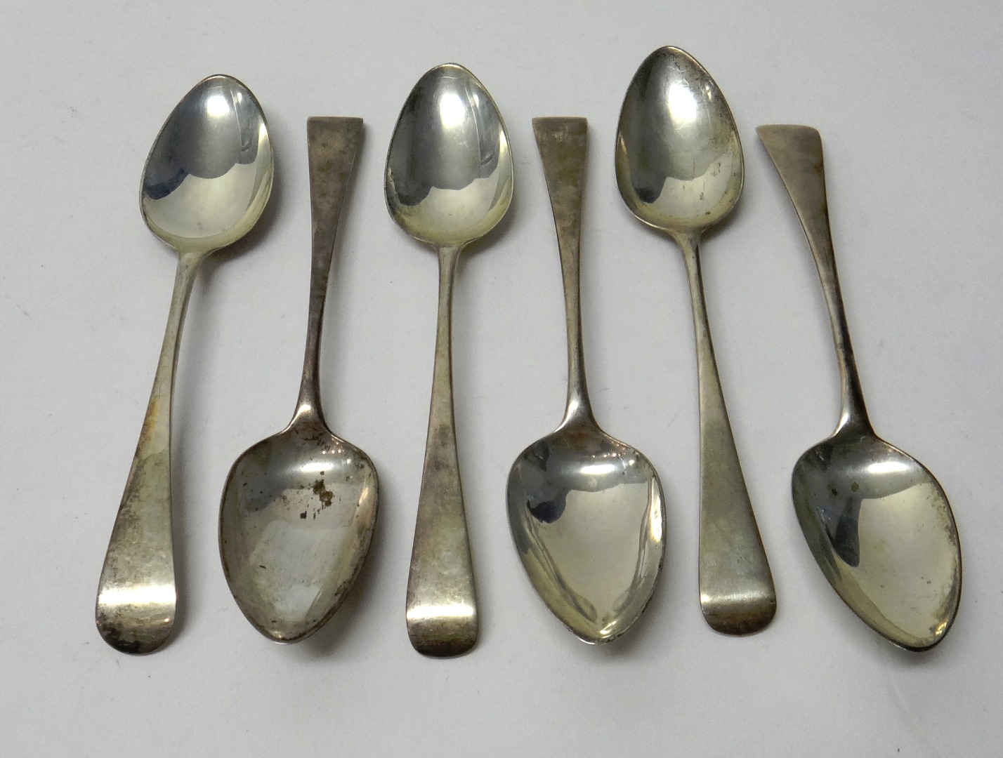 Appraisal: Six silver Old English pattern dessert spoons comprising four London