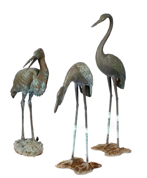 Appraisal: A group of three patinated bronze models of cranes height