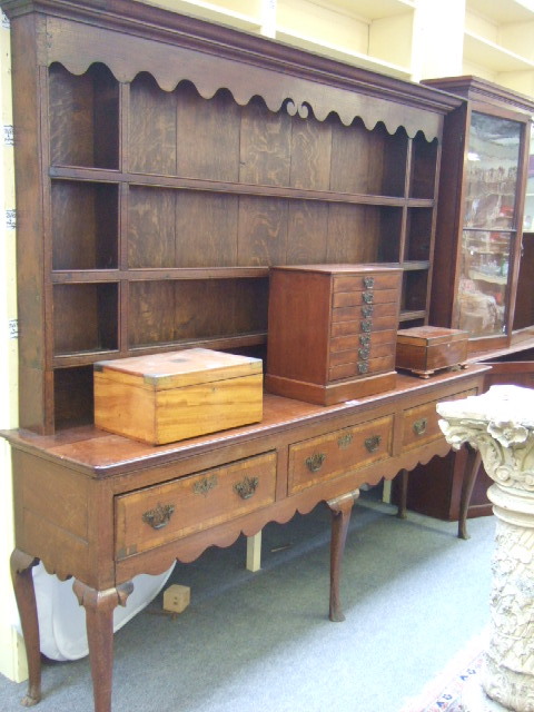 Appraisal: A mid th century oak dresser the enclosed three tier