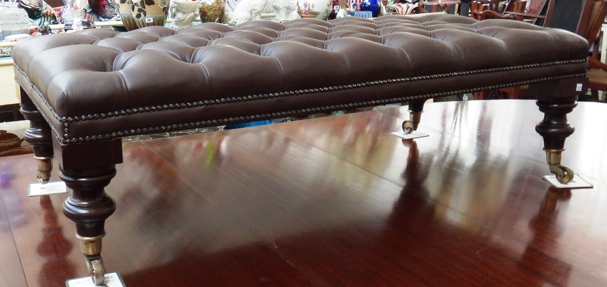 Appraisal: A Regency design large footstool the overstuffed button leather top