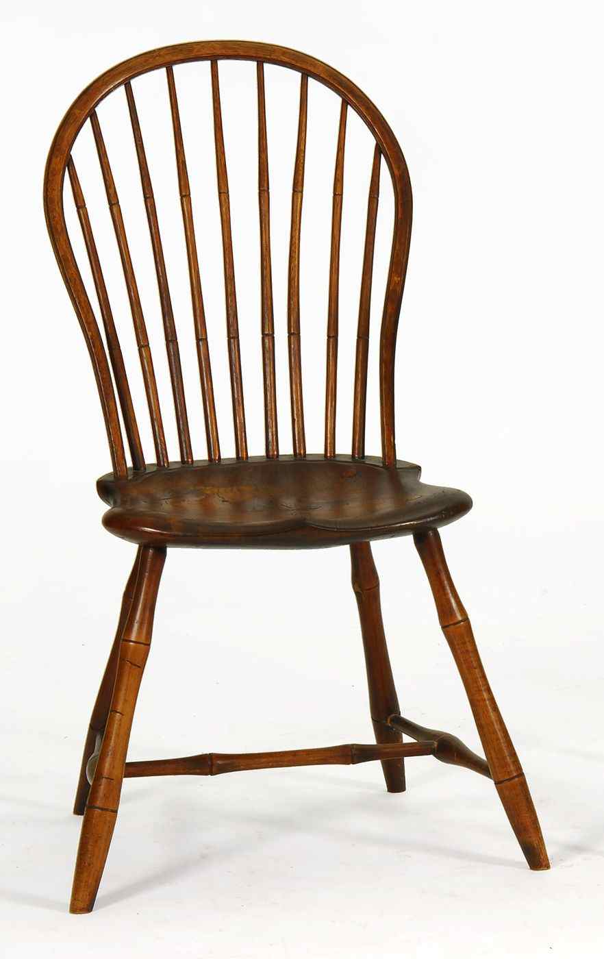 Appraisal: ANTIQUE BOWBACK WINDSOR CHAIRCirca With natural finish Waisted molded nine-spindle