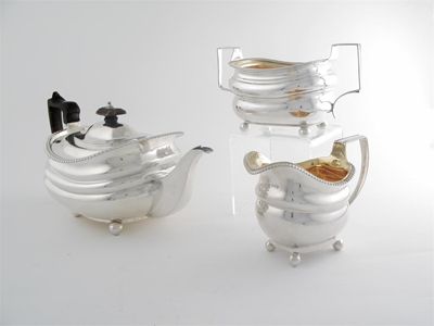 Appraisal: A George III teapot and cream jug and sugar basin