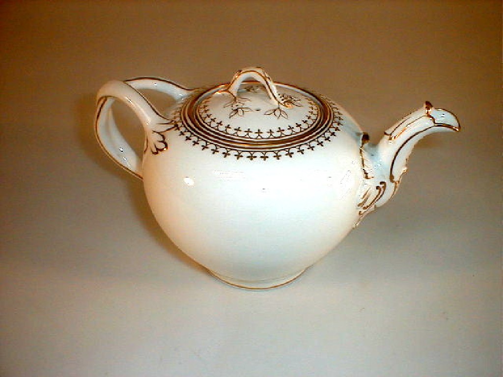 Appraisal: A Minton white - ground porcelain teapot of ovoid form