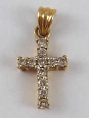 Appraisal: A yellow metal tests carat gold diamond cross approx cm