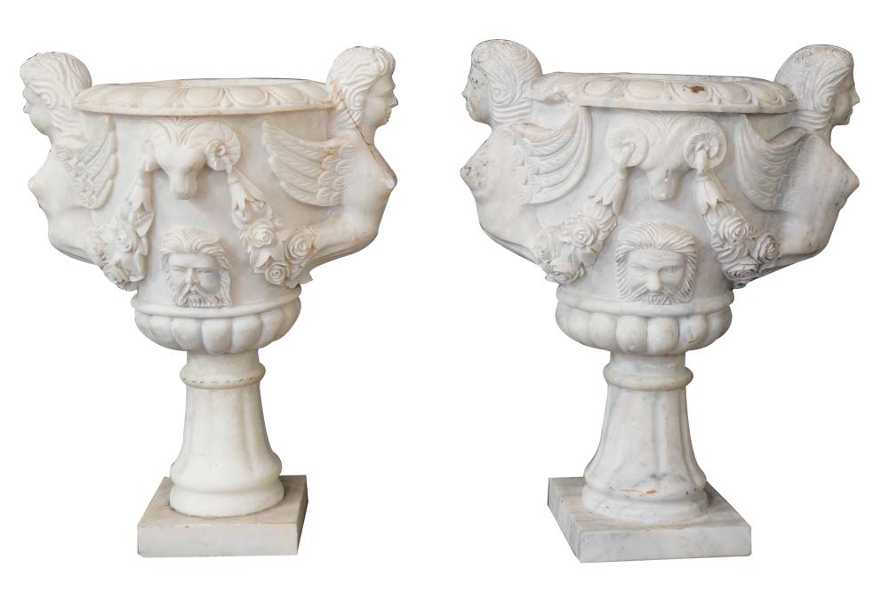 Appraisal: PAIR OF LARGE CARVED MARBLE URNSeach flanked by winged figures