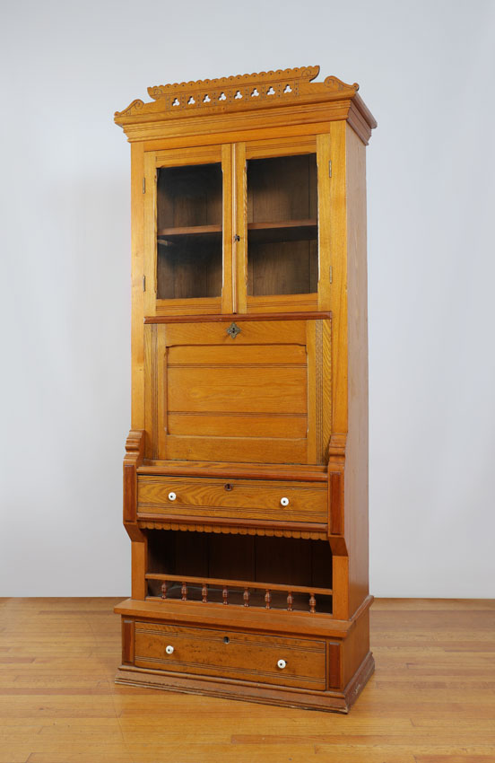 Appraisal: EASTLAKE OAK SECRETARY BOOKCASE Pierced carved pediment over glass doors