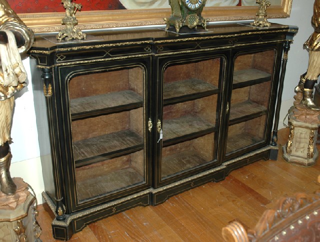 Appraisal: A VICTORIAN EBONISED BOOK CABINET The rectangular breakfront top with