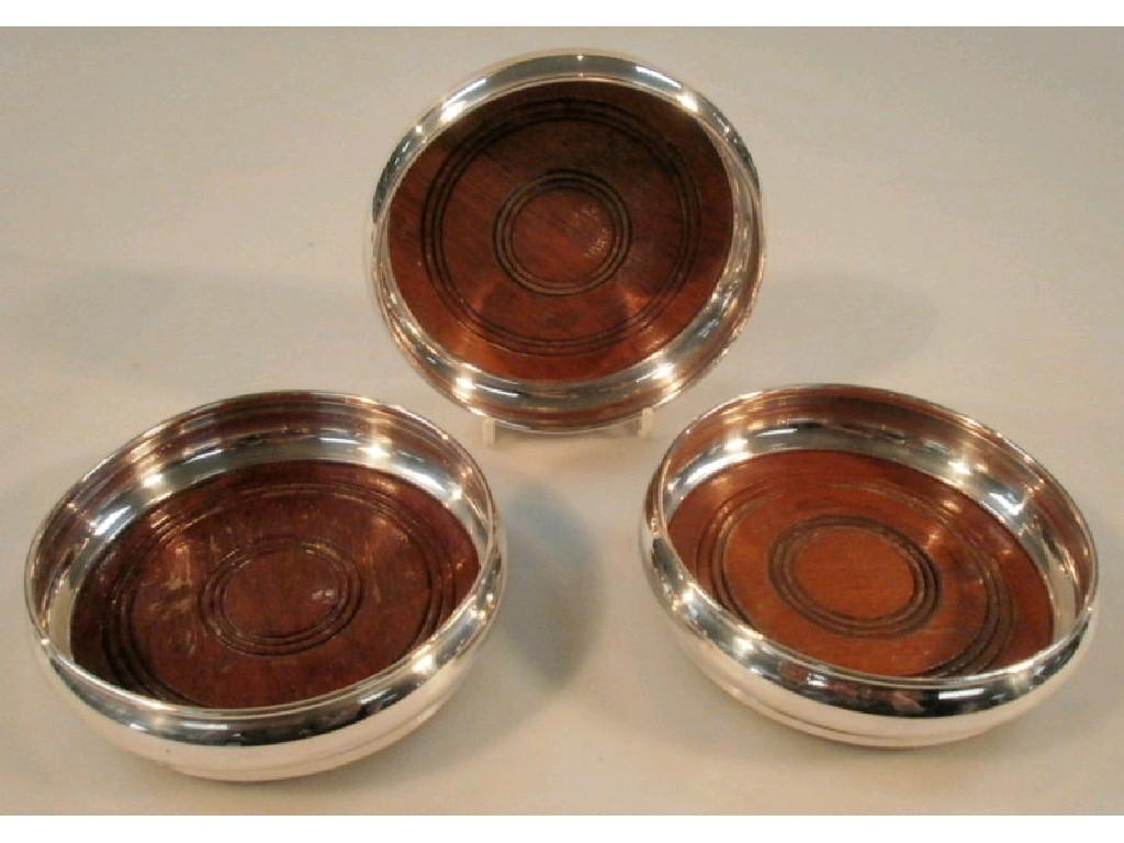 Appraisal: Three modern matching silver wine coasters of plain design Birmingham