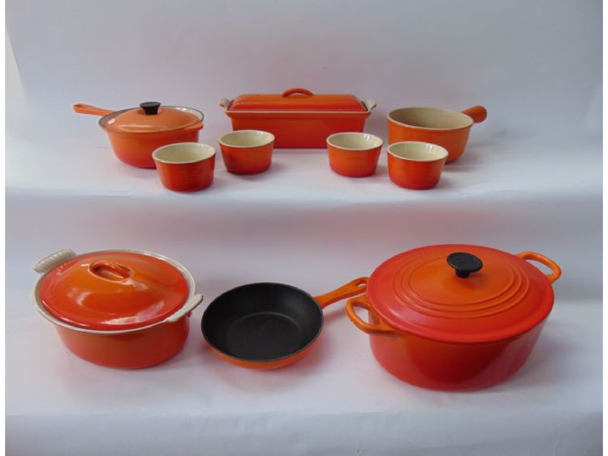 Appraisal: A collection of Le Creuset wares with orange finish comprising