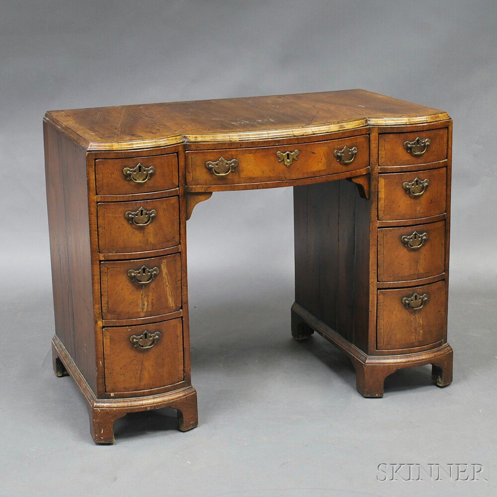 Appraisal: Continental Walnut Veneer Kneehole Desk th century the bowed thumbmolded