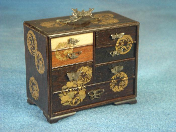 Appraisal: Minature rosewood Japanese seven drawer chest gold lacquered floral decoration