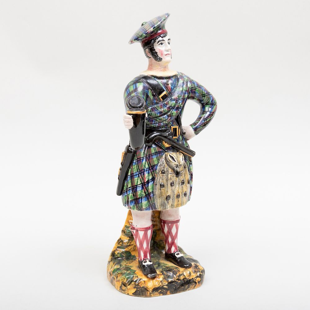 Appraisal: Staffordshire Pearlware Figure of a Scotsman in high Condition Minor