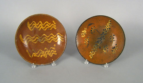 Appraisal: Two slip decorated redware plates th c dia and dia