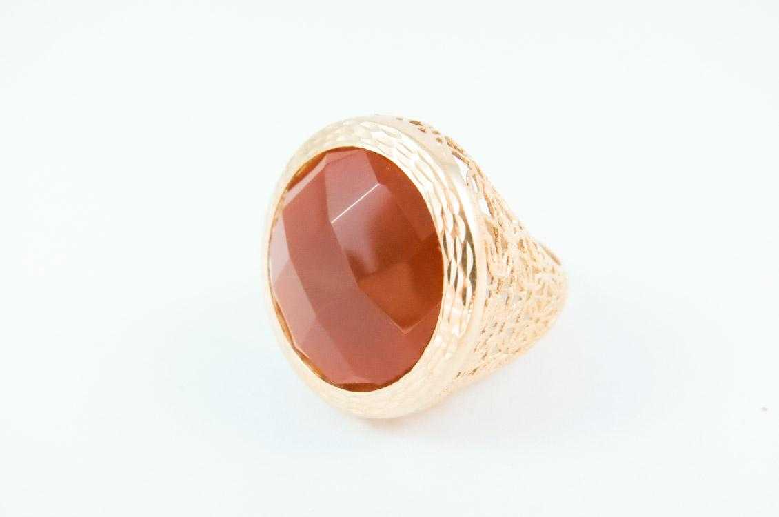 Appraisal: PAOLA VALENTINI CARNELIAN AND YELLOW GOLD RING The pierced k