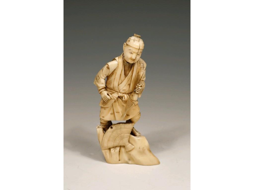 Appraisal: A JAPANESE IVORY OKIMONO of a man holding a fish