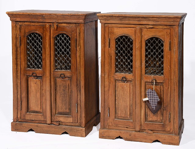 Appraisal: A pair of reproduction Indian style cupboardseach with iron doors