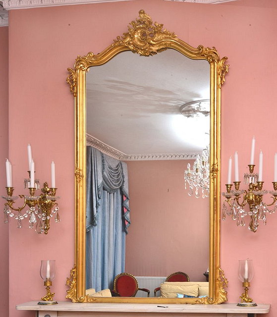 Appraisal: A REPRODUCTION LARGE GILTWOOD OVERMANTEL MIRROR with asymmetric scroll mount