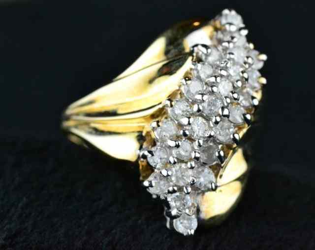 Appraisal: LADY'S DIAMOND RINGConsisting of karat yellow gold swirl band grams