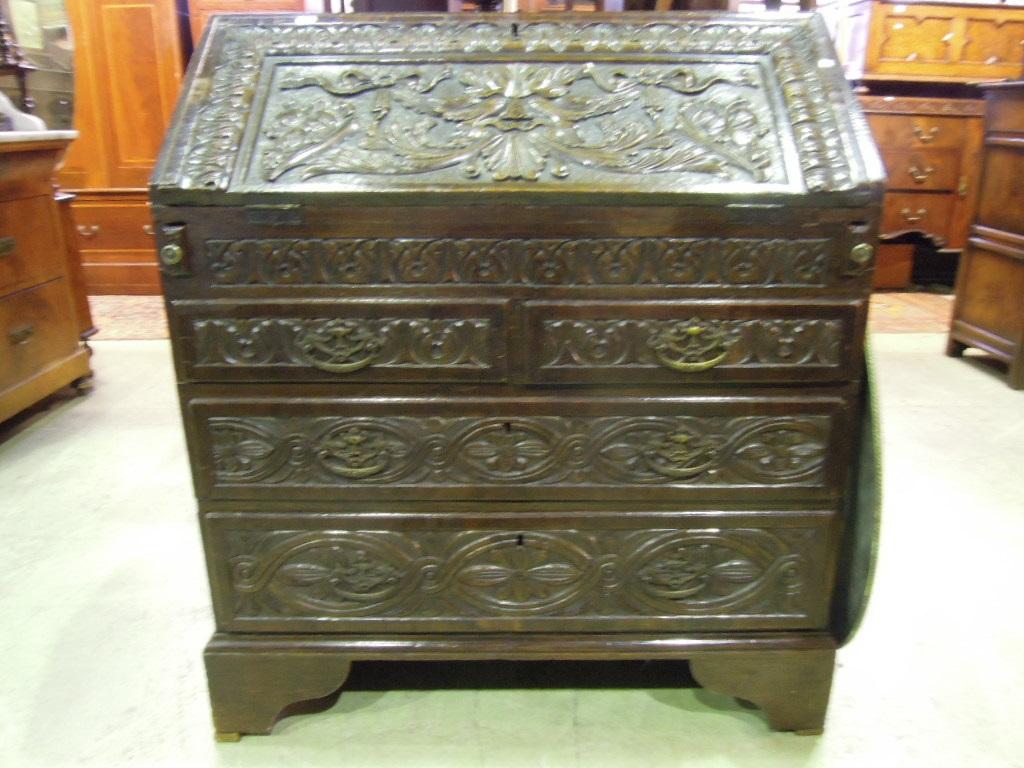 Appraisal: A Georgian oak bureau with later Victorian carved detail the